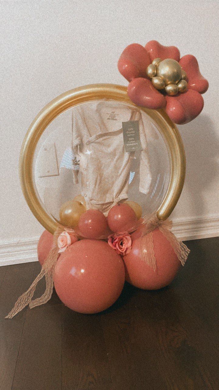 Elegant Baby Shower Balloon Gift Display with Gold and Pink Accents